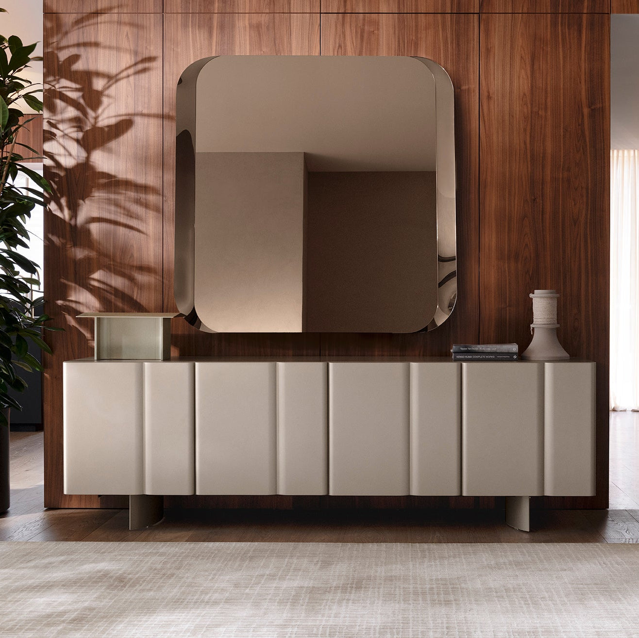 Modern sideboard with large mirror against a wooden wall.