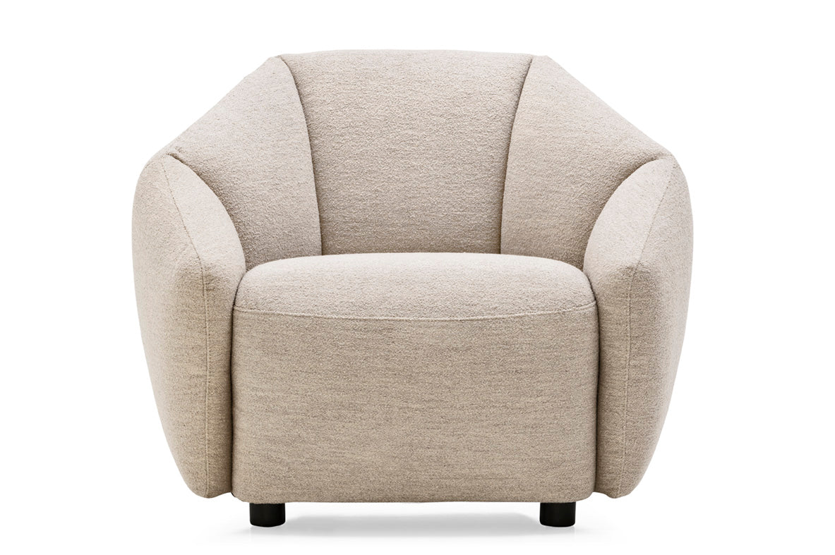 A modern barrel-style armchair upholstered in a textured light beige fabric, shown from the front against a plain white background.