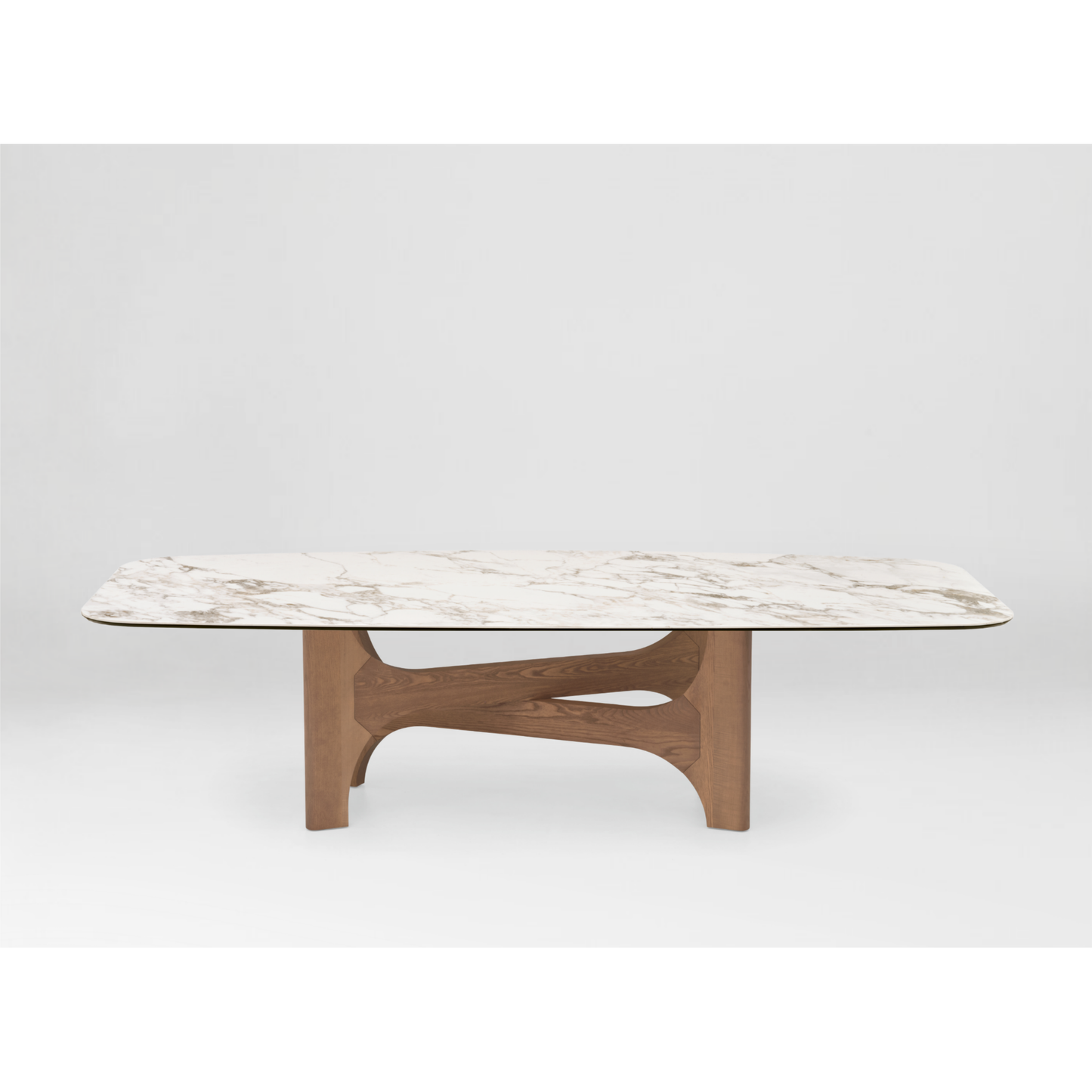 A modern rectangular coffee table with a white marble-look top featuring subtle gray veining and a sculptural, curved wooden base in a medium brown finish, shown against a light gray studio background.