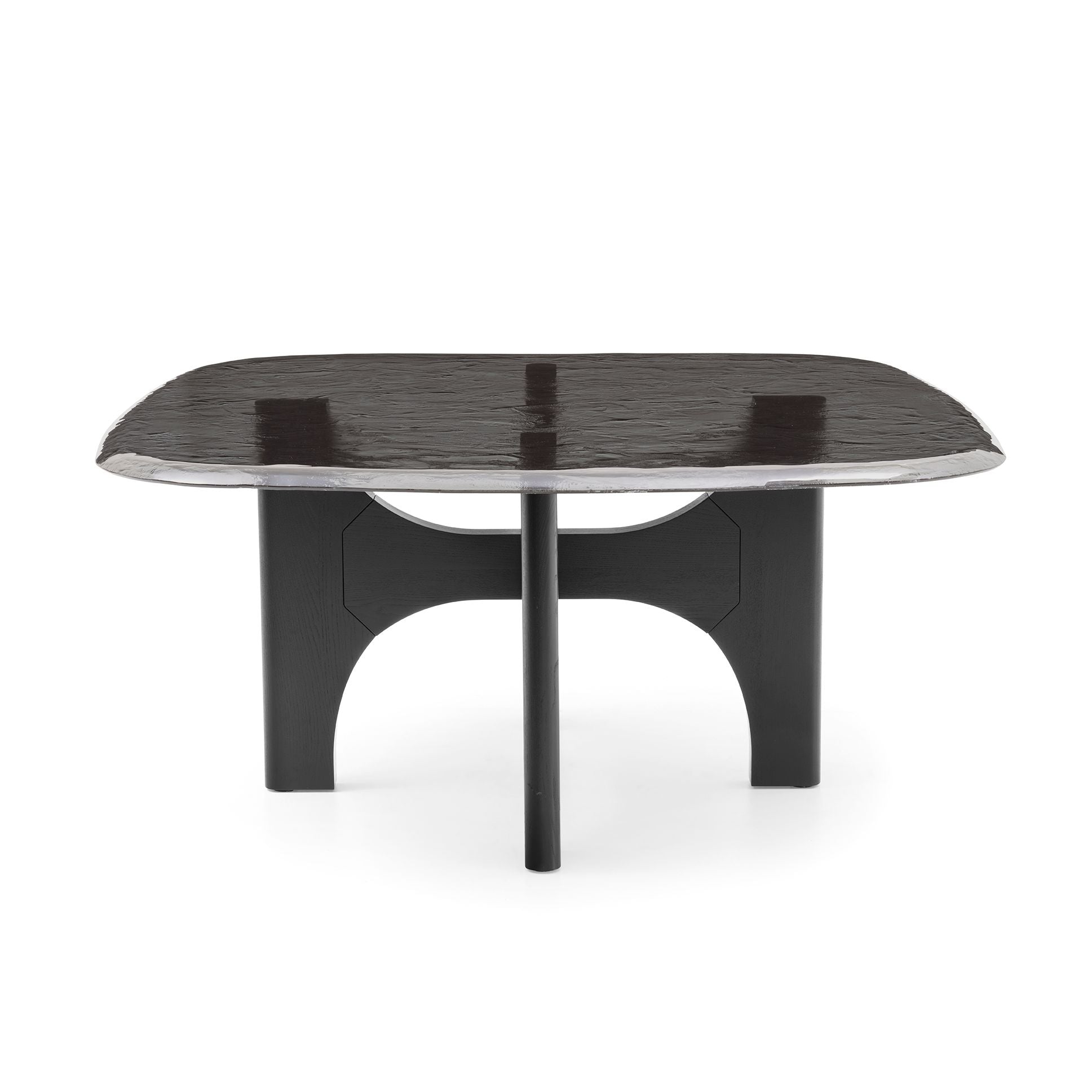 A modern black dining table with a rounded rectangular top, a central pedestal base, and a polished silver metallic rim, shown on a white background.